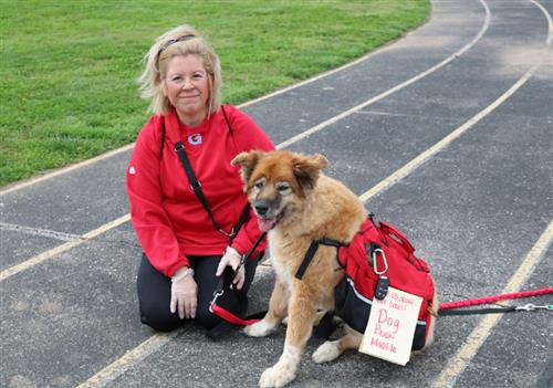 Nicole Bueno and her dog, Honey, wearing a backpack 